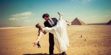 Romantic Honeymoon couple walking near the Pyramids of Giza
